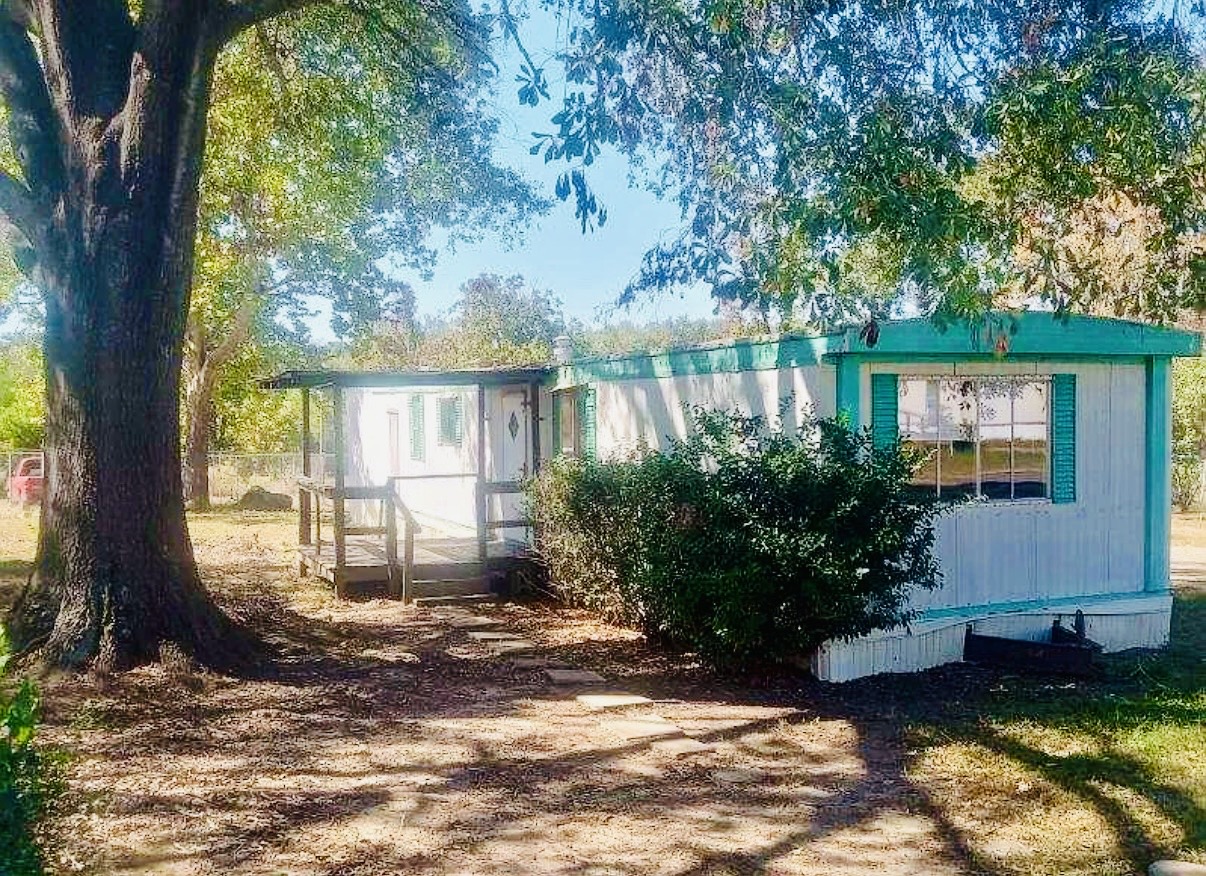 Rental home beneath mature trees on Hillside Circle in Stonewall Louisiana
